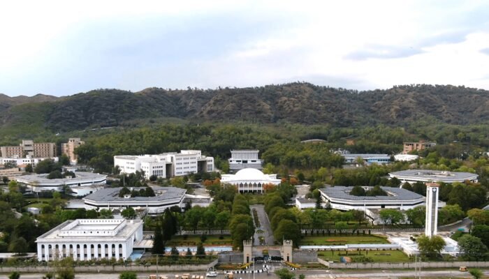 GIK Institute campus, Topi Aerial view of the GIKI campus in Topi: academic blocks with round domed halls among trees, with green hills behind