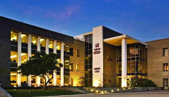 The Aman CED building at IBA Karachi lit up at dusk